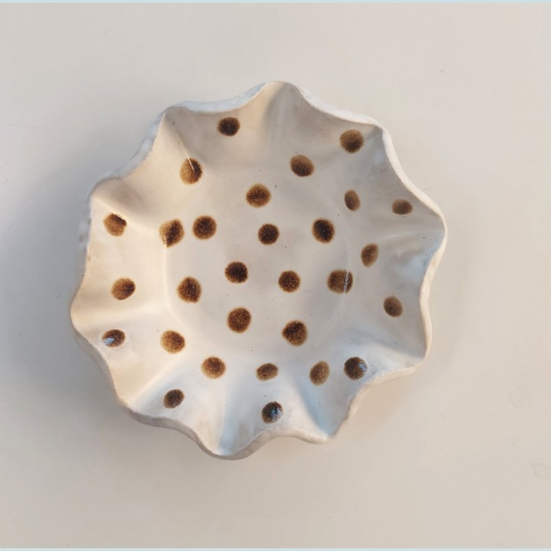 Fyrfadsstager med brune prikker