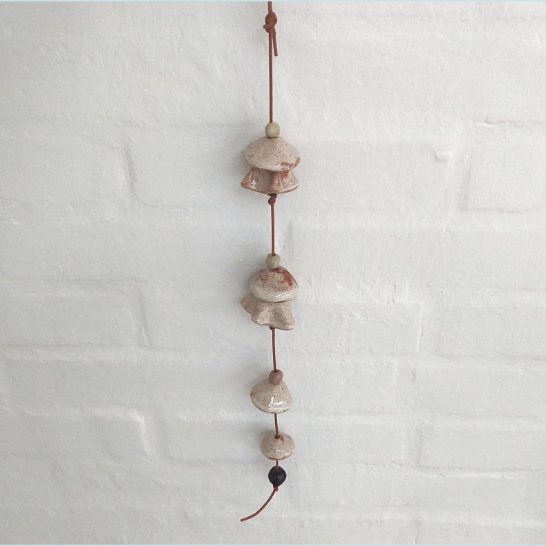 Vindklokke i l�dersnor. Farve: Creme med rustr�de nister. F�rpris 199,- udsalgspris 179,-